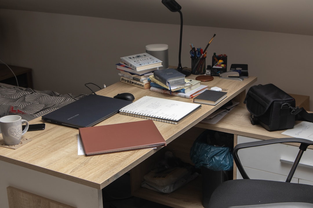 a wooden desk topped with a laptop computer student desk, organizing pdf files, college notes
