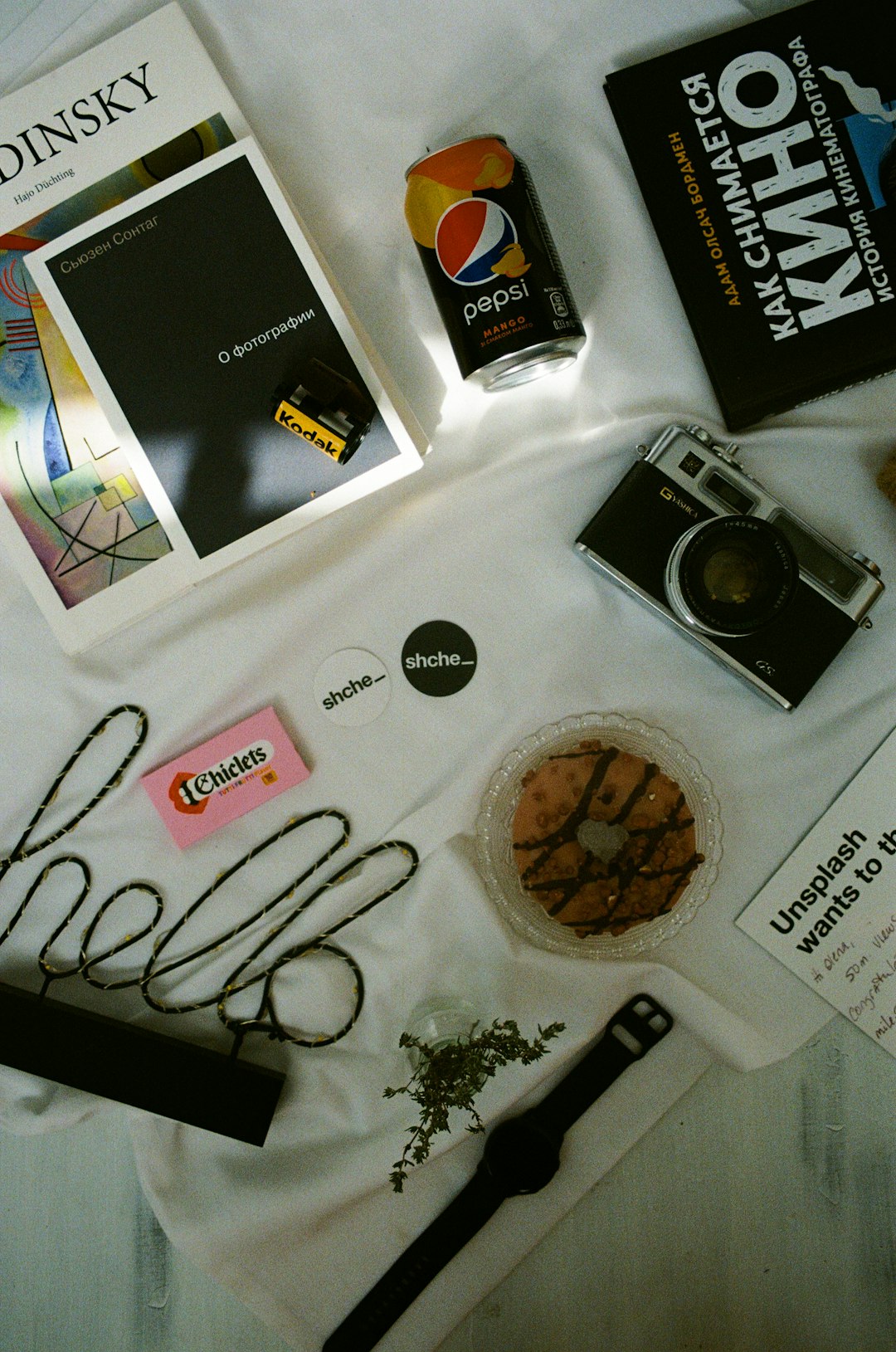 black and silver camera beside black and white box branding kit, fashion label, logo design process