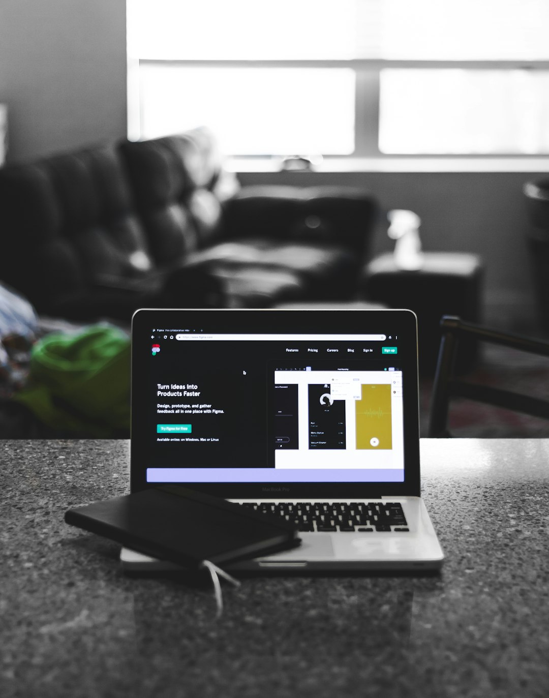 focus photo of black and white laptop computer turned on figma interface, collaborative design, freelancers