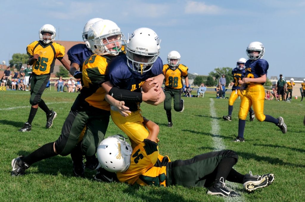 football players struggling to hold the football during daytime bills quarterback josh allen action