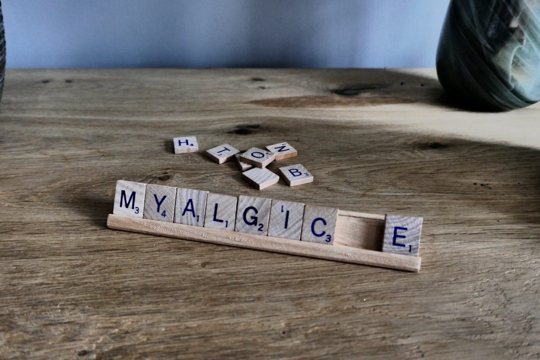 Scrabble tiles spell 'myalgic' on wooden surface template strings, placeholders, name age, javaScript replace