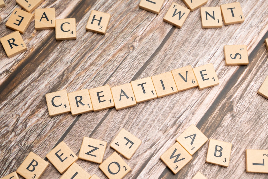 scrabble tiles spelling out the word creative creative marketing, happy customer, ad success