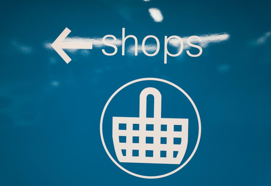 a blue sign with a shopping basket on it future ecommerce website, shopping trends, technology integration