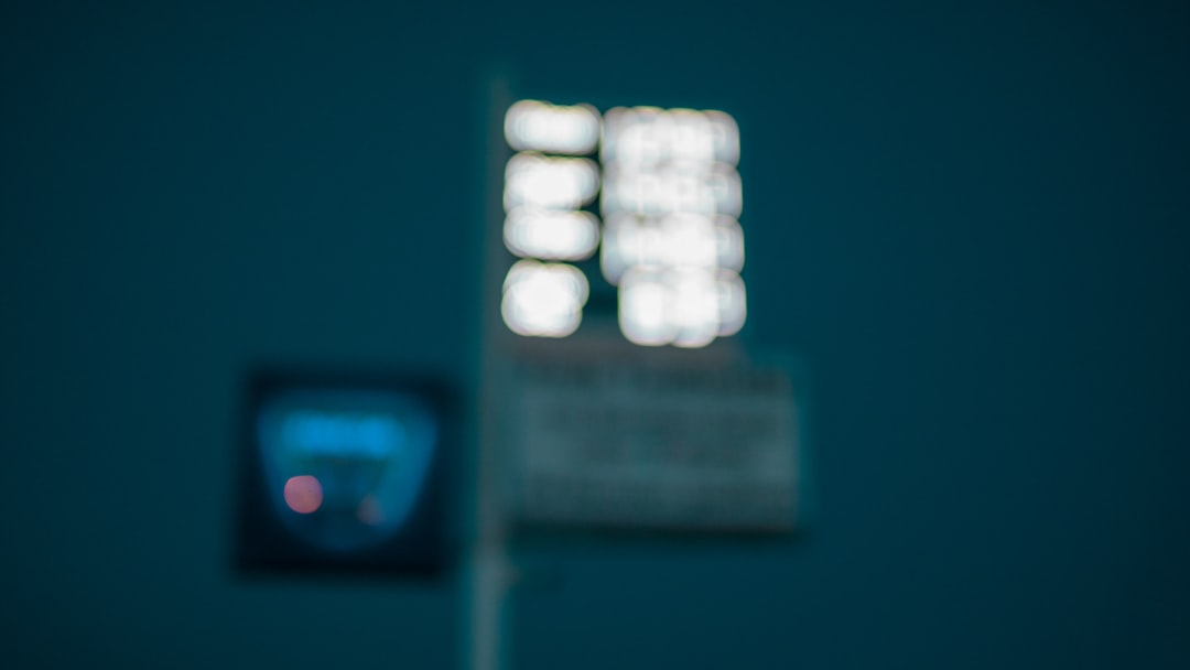 a blurry photo of a street sign and a traffic light football field scoreboard night game, dramatic fourth quarter, nfl fans cheering