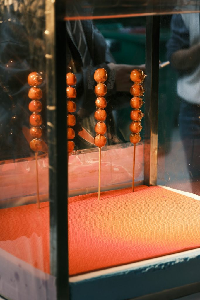 a bunch of food is being cooked on a stick lottery balls machine, numbered balls, drawing in progress