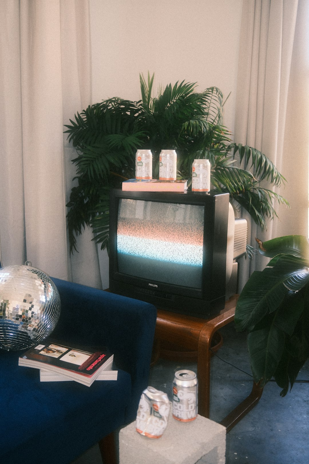 a living room with a blue couch and a television super bowl party setup living room, football decorations, snacks and screen