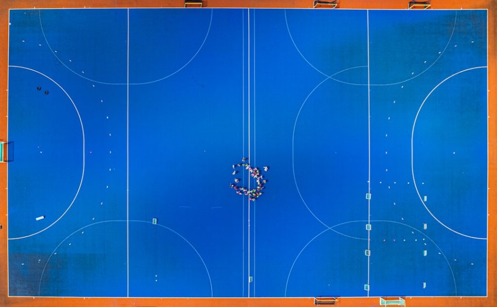 An overhead shot of a basketball court shuffleboard scoring zones diagram, 10 8 7 sections, penalty area minus 10, labeled court view