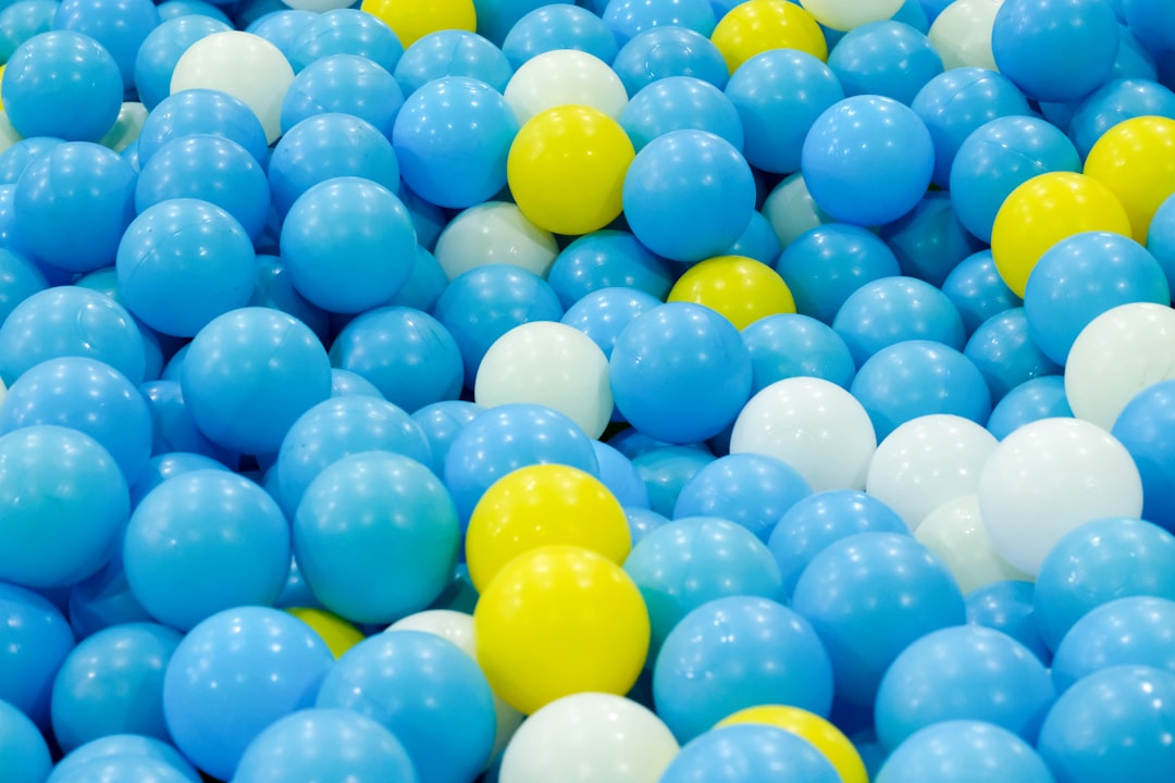 blue yellow and green balloons office lottery pool, coworkers holding tickets, celebration concept