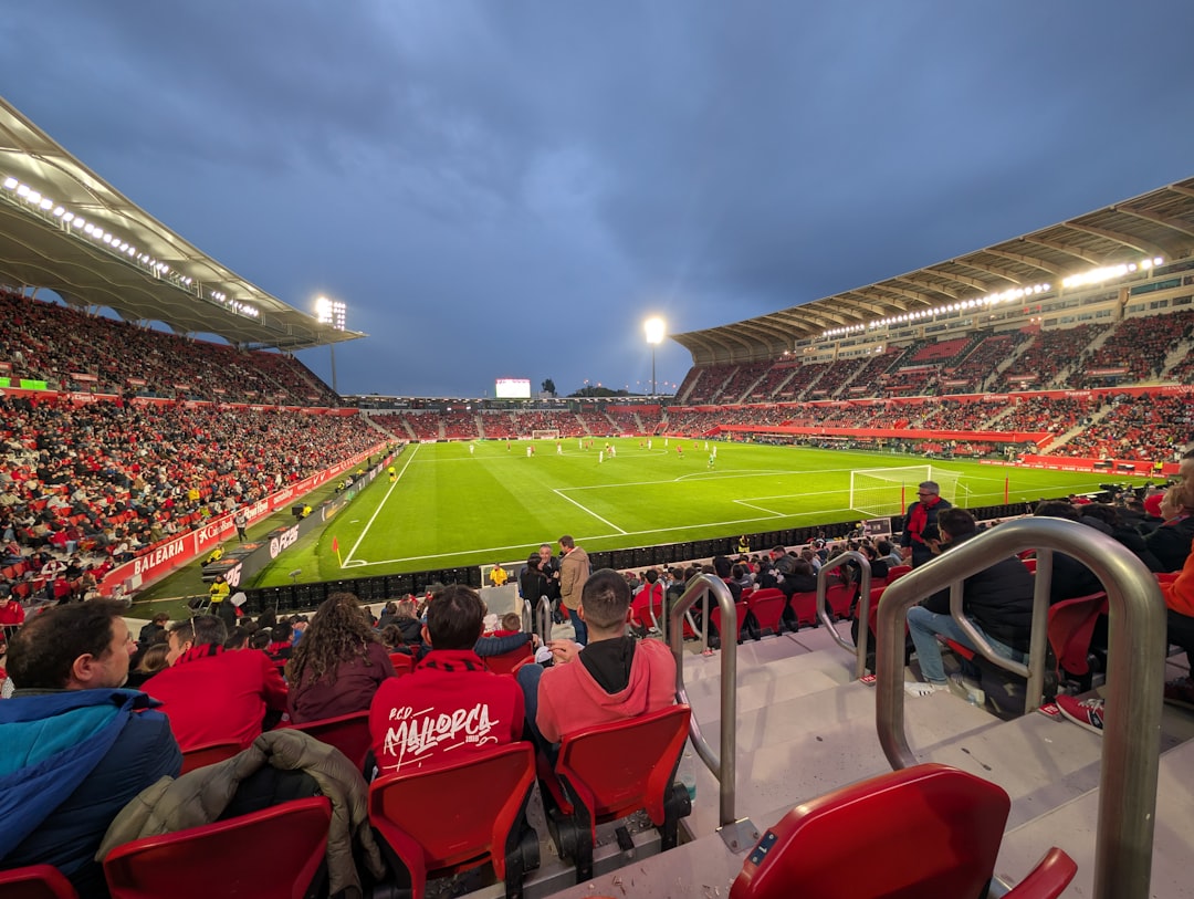 Crowded soccer stadium with fans watching a game. football stadium crowd night lights