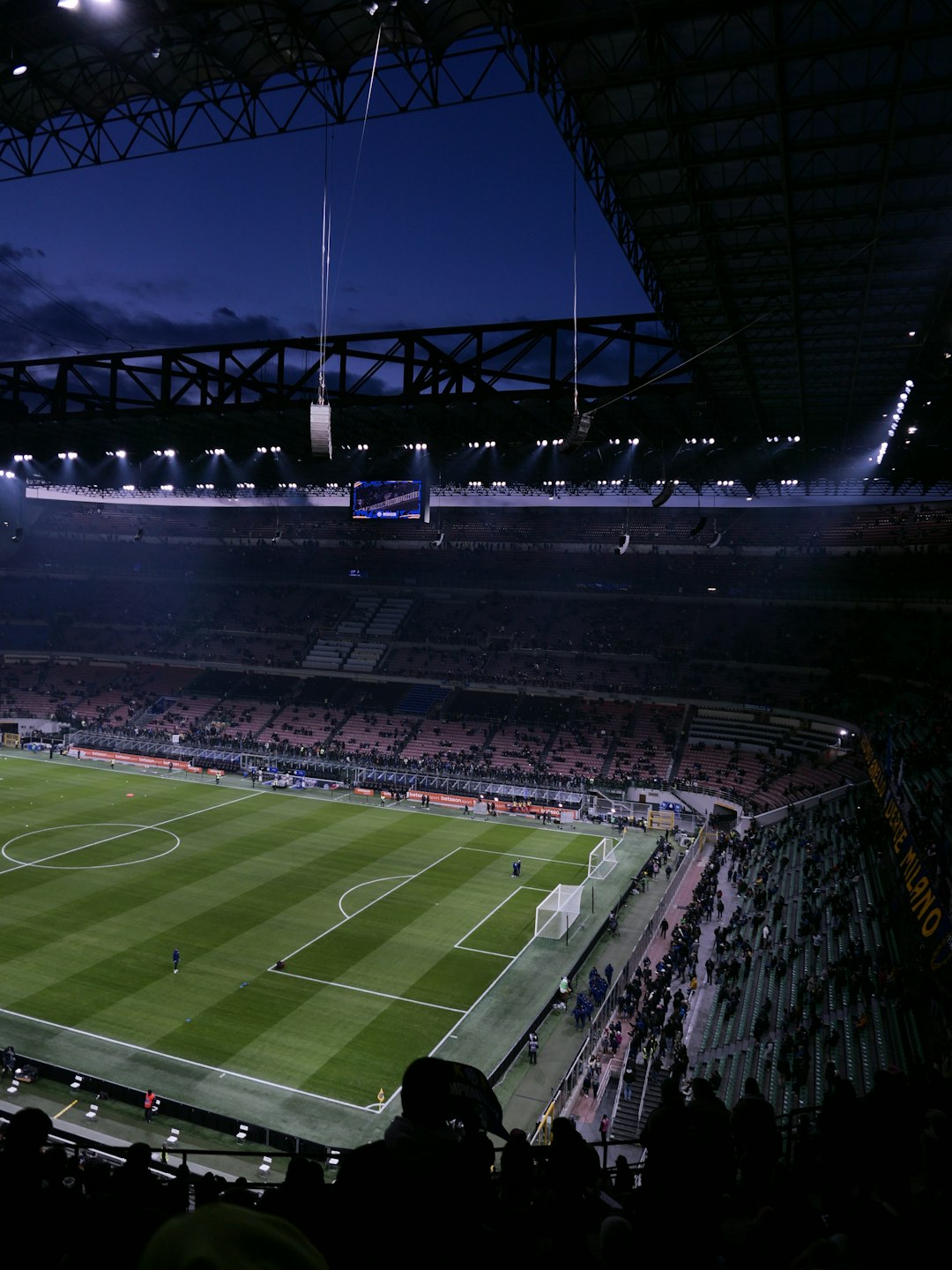 Empty soccer stadium at dusk with lights on football stadium crowd night lights