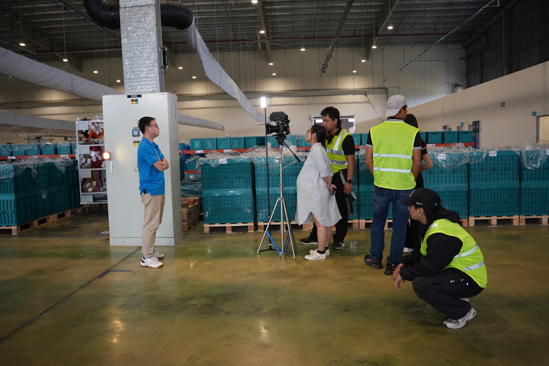 Film crew records a man in a warehouse setting. supply chain, warehouse, inventory management