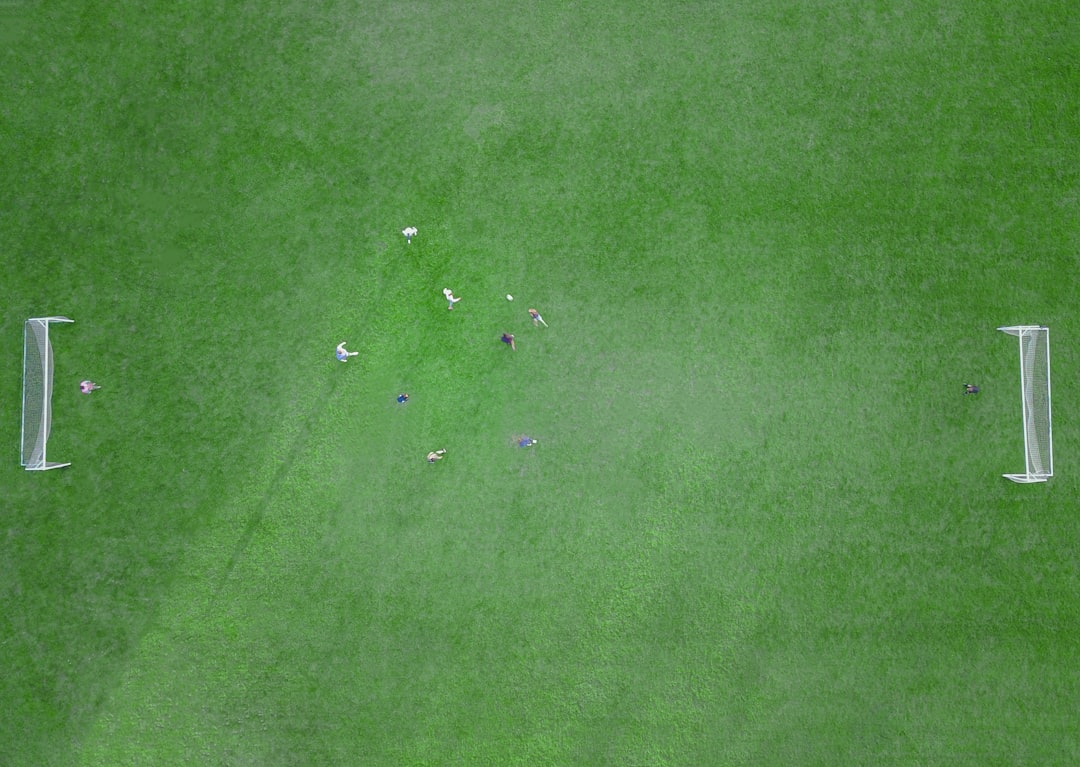 green textile with white button midfield battle football match, player marking duel, tactical matchup