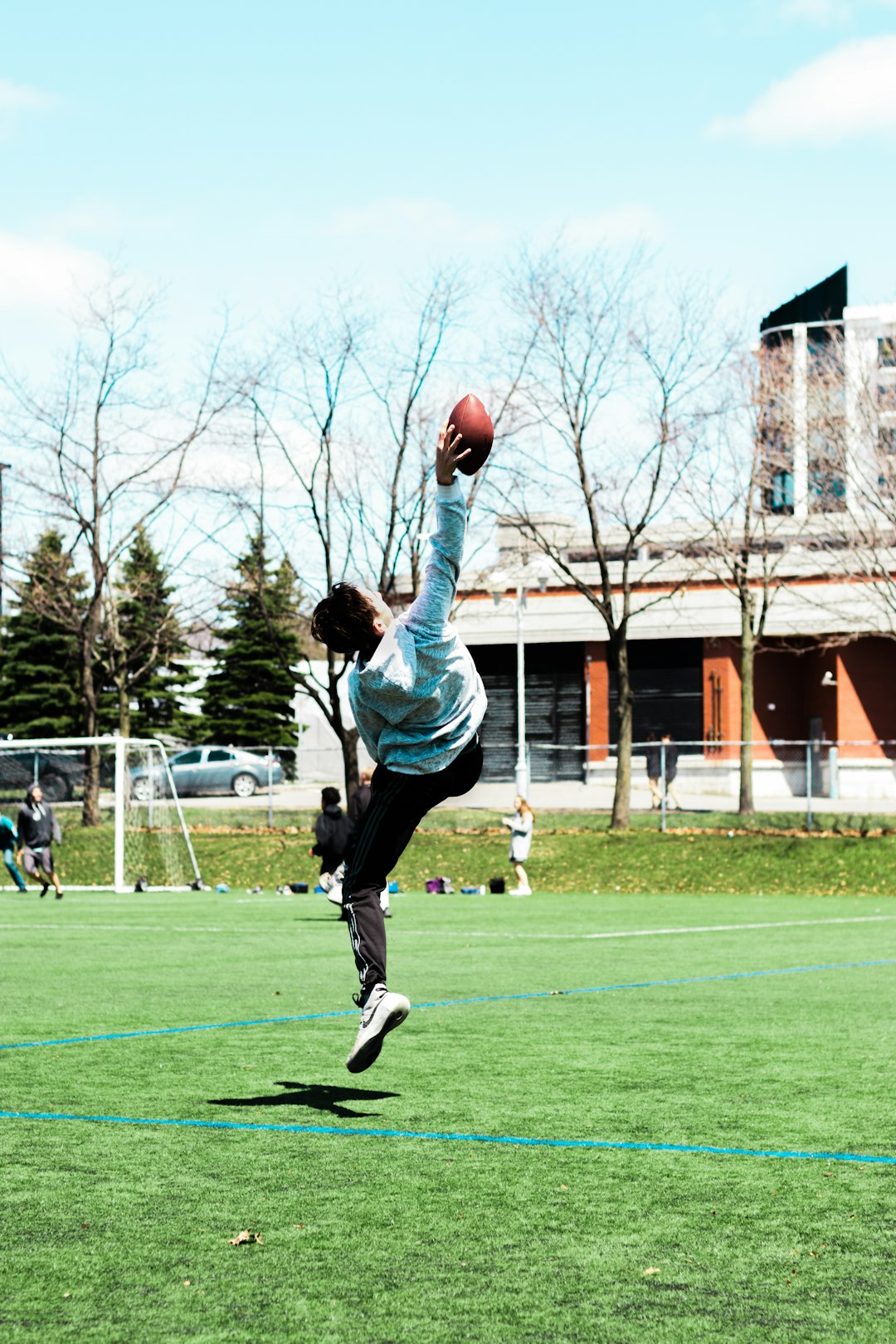 man catching football at the field quarterback throwing football, nfl stadium lights, football action shot