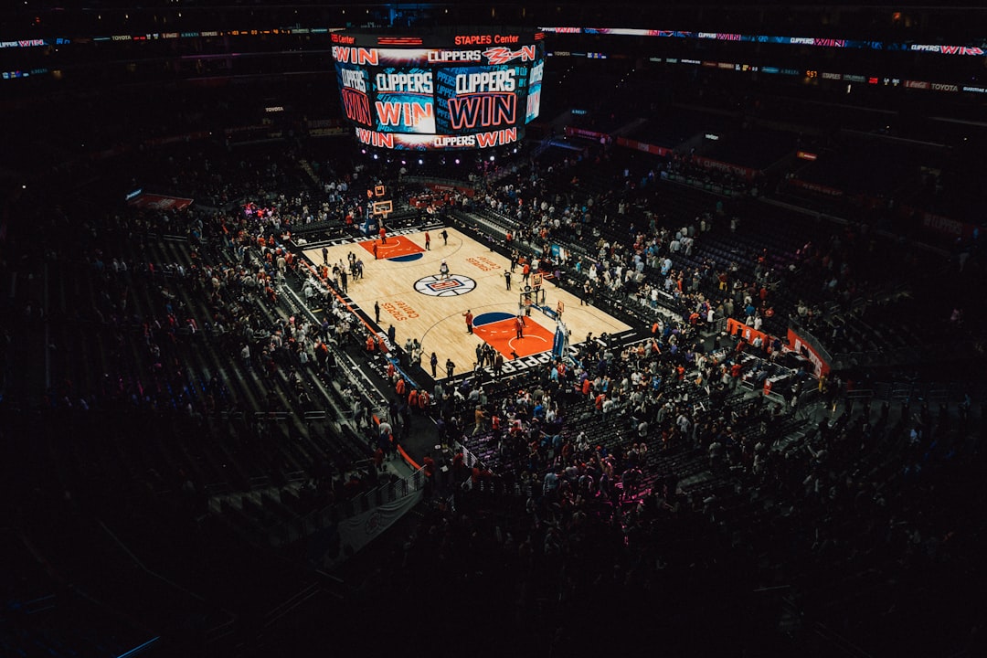 people watching football game during nighttime Timberwolves vs Lakers matchup, basketball tip off, NBA arena crowd