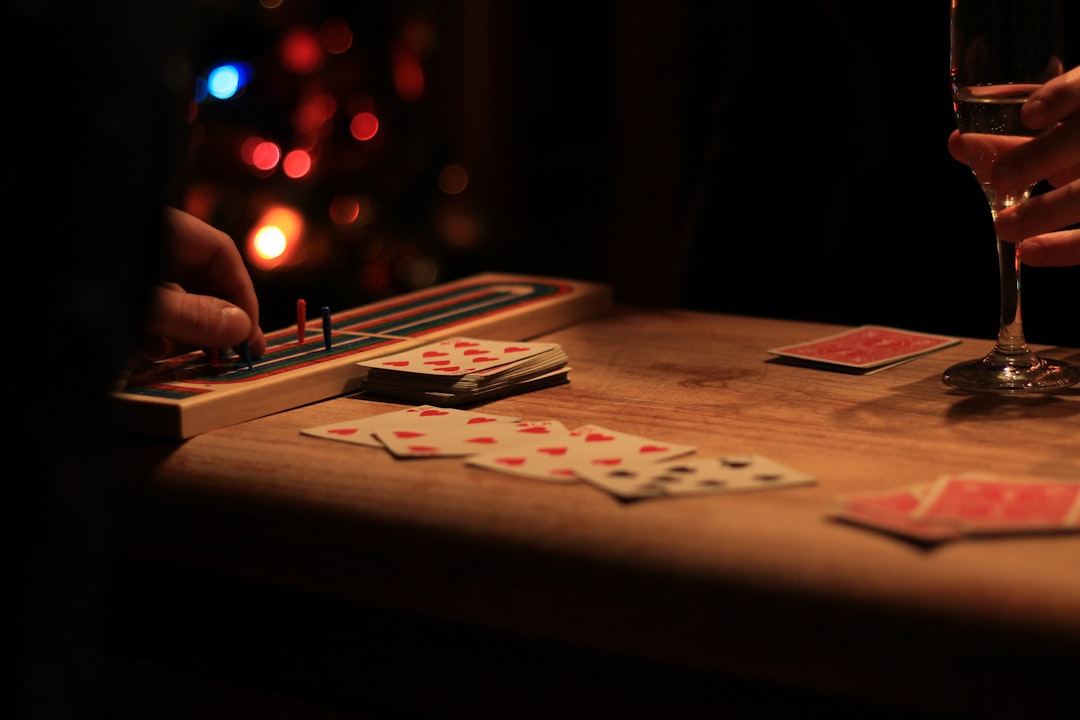 playing cards on brown wooden table cribbage hand scoring, cards arranged, counting points, five card hand table