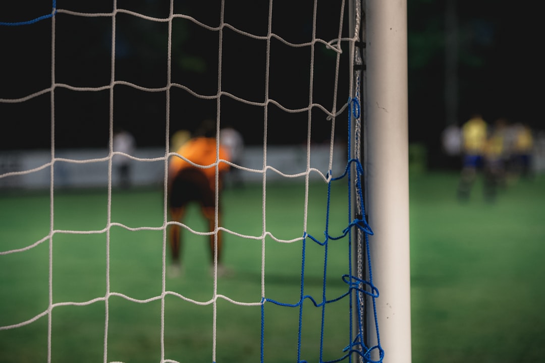 soccer goal on soccer field soccer player scoring goal close range stadium lights