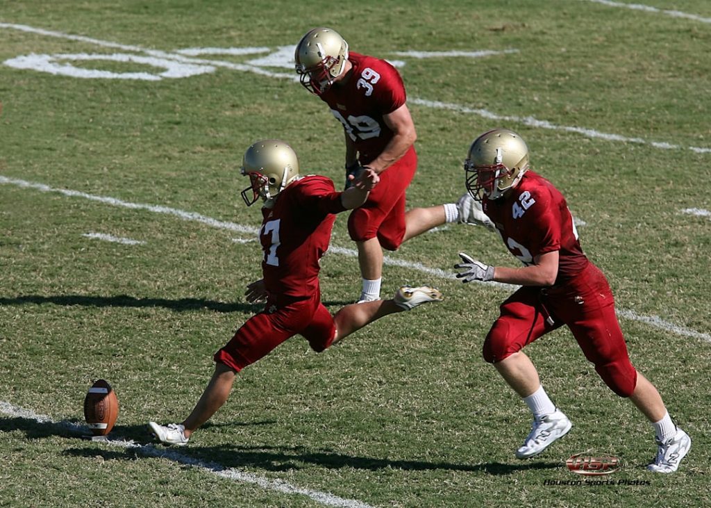 three football players running towards football ball at field during daytime nfl running back action, football handoff close up, defensive tackle attempt