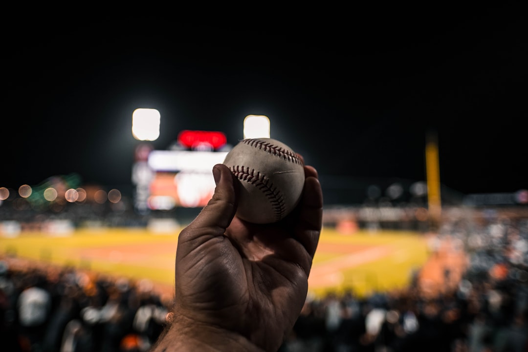 white baseball baseball pitcher throwing fastball, close up mound action, stadium lights night game
