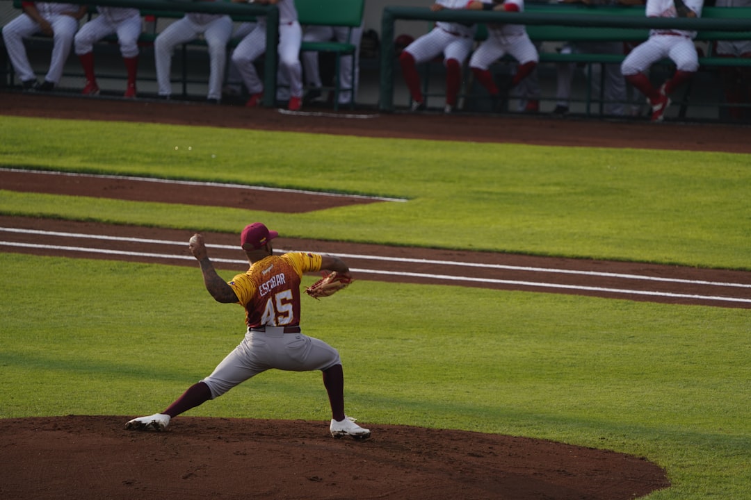a baseball player pitching a ball on top of a field close up baseball pitcher release point, high arm angle, fastball motion