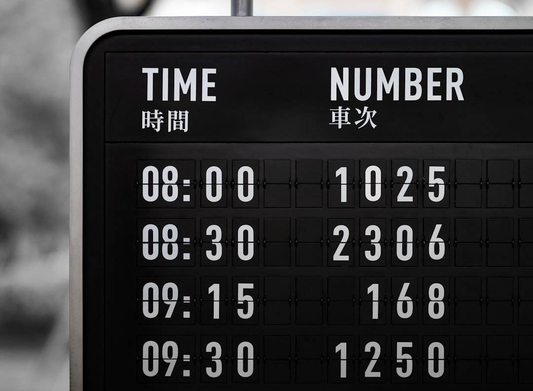 a black and white photo of a clock and a sign baseball scoreboard close up, player stats screen, fantasy points graphic