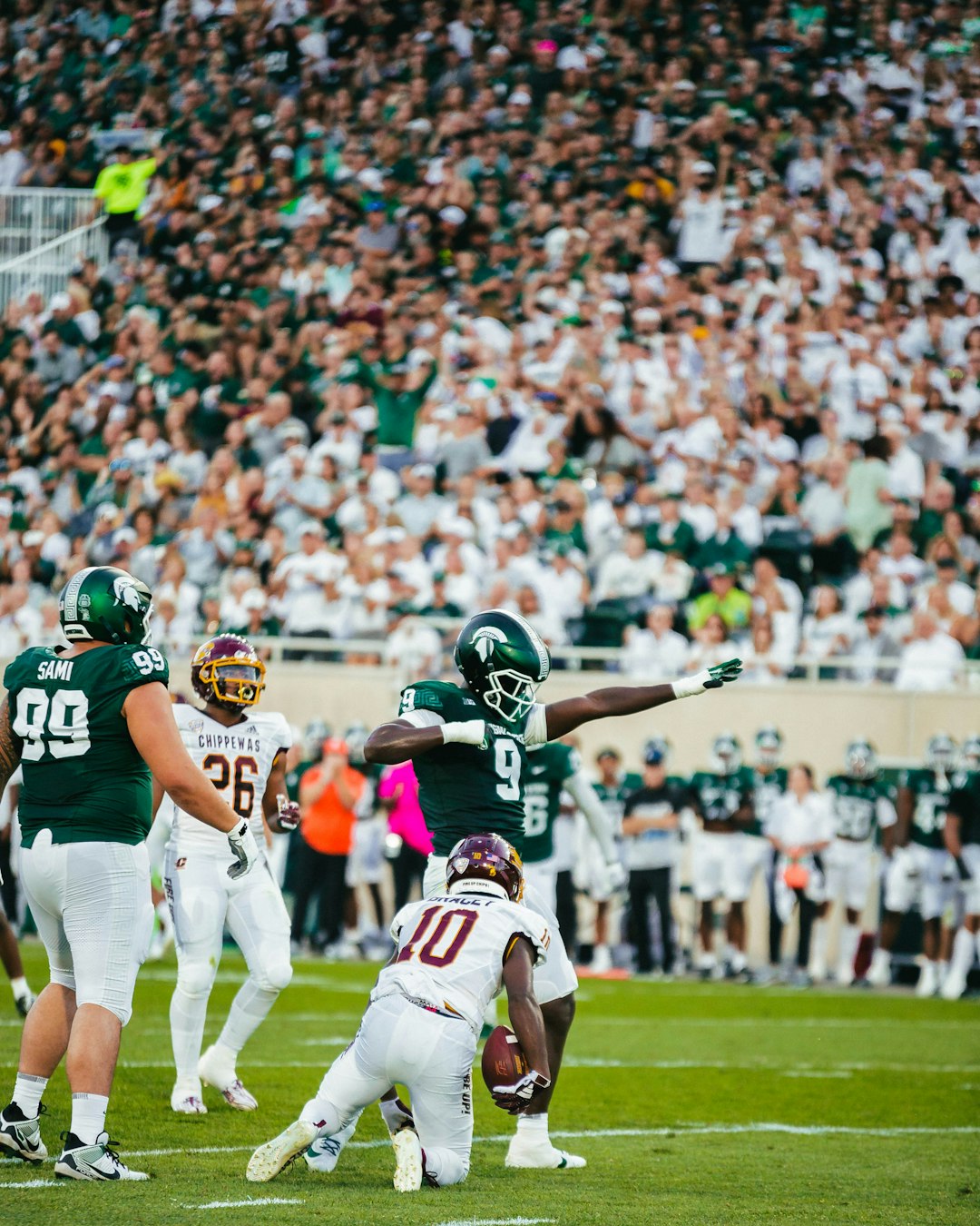 A football player throwing a ball during a game punt return touchdown, blocked field goal attempt, special teams celebration