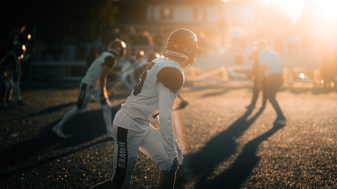 a group of people in a field football player silhouette, blurred nfl player, guessing game concept