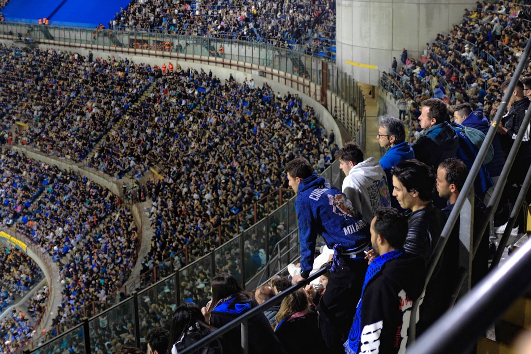 a large crowd of people in a stadium San Siro stadium crowd, Bari home stadium fans, 1990s Serie A match action