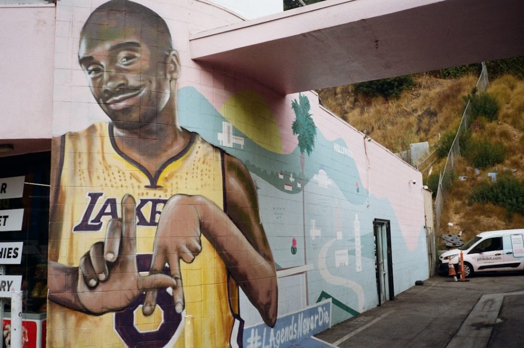 A mural of a basketball player on the side of a building anthony davis standing full body, basketball court background, los angeles lakers uniform