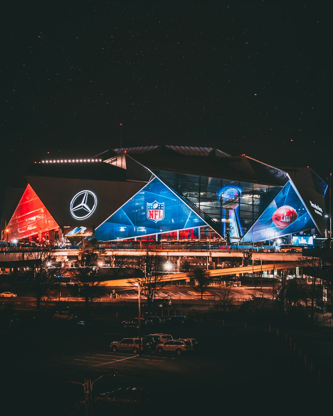 a stadium lit up at night with a lot of lights atlanta falcons defense, nfl linebacker rushing quarterback, mercedes benz stadium interior
