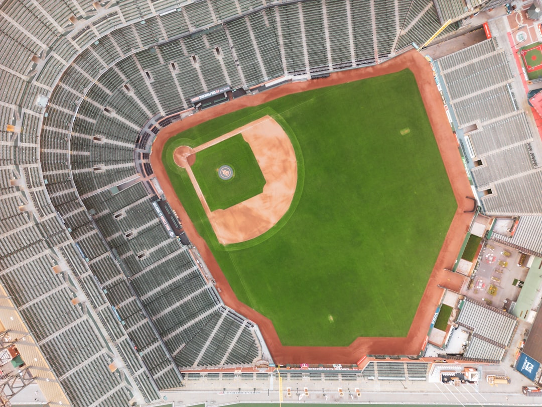 an aerial view of a baseball field in a stadium baseball stadium aerial view, sunny day game, crowd in stands