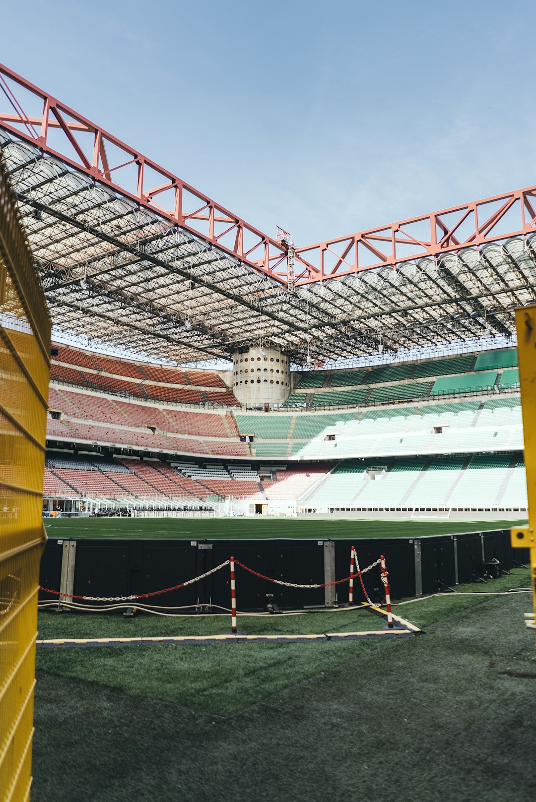 an empty stadium with grass and yellow barriers San Siro stadium crowd, Bari home stadium fans, 1990s Serie A match action
