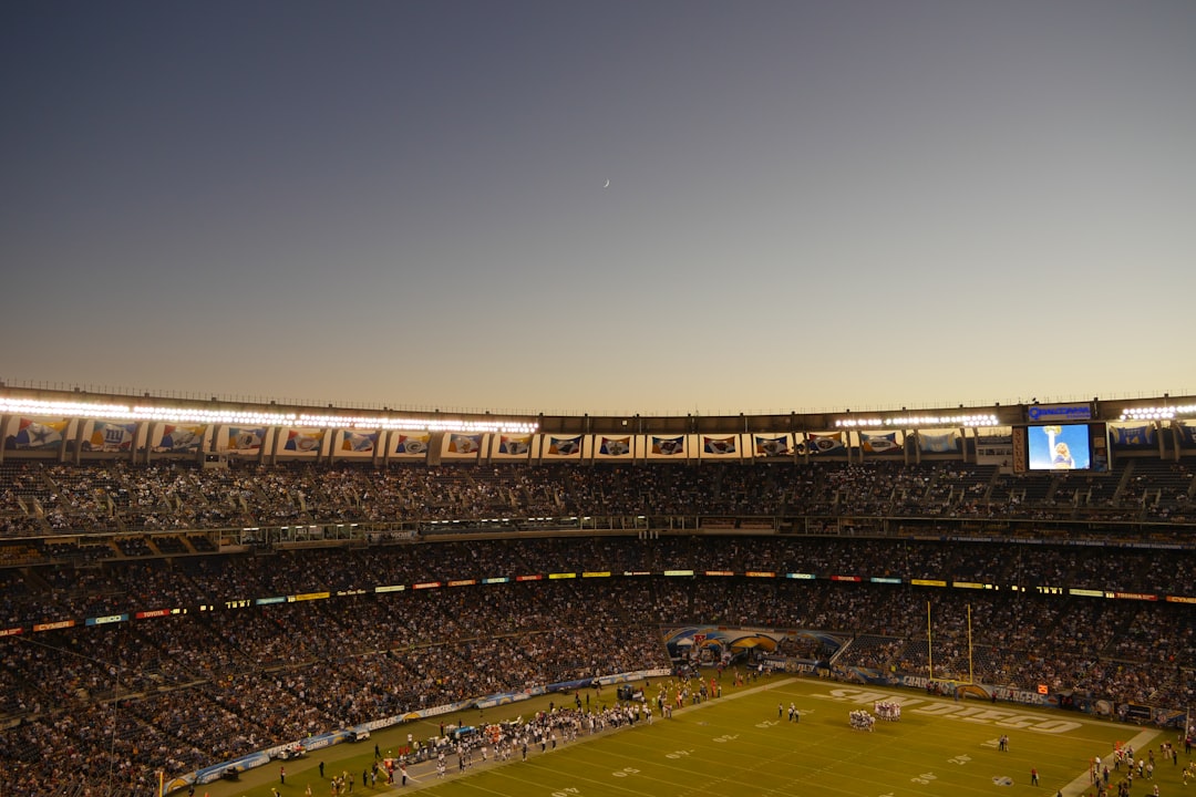 football field football quarterback throwing pass, wide receiver catch, nfl stadium crowd