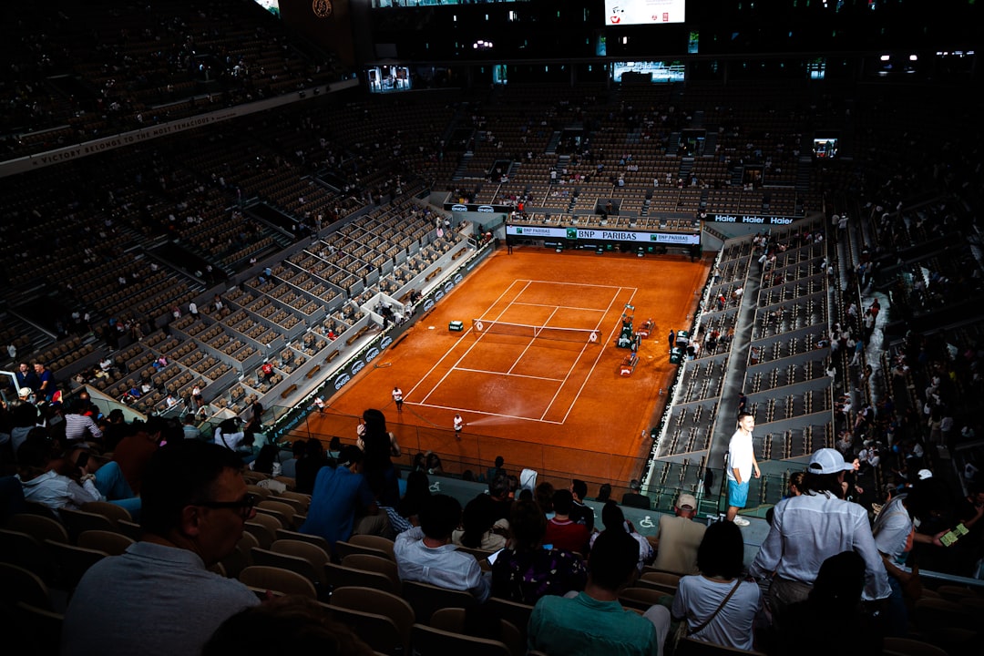 Tennis match at a large stadium with spectators. roland garros crowd, philippe chatrier court, paris spring atmosphere