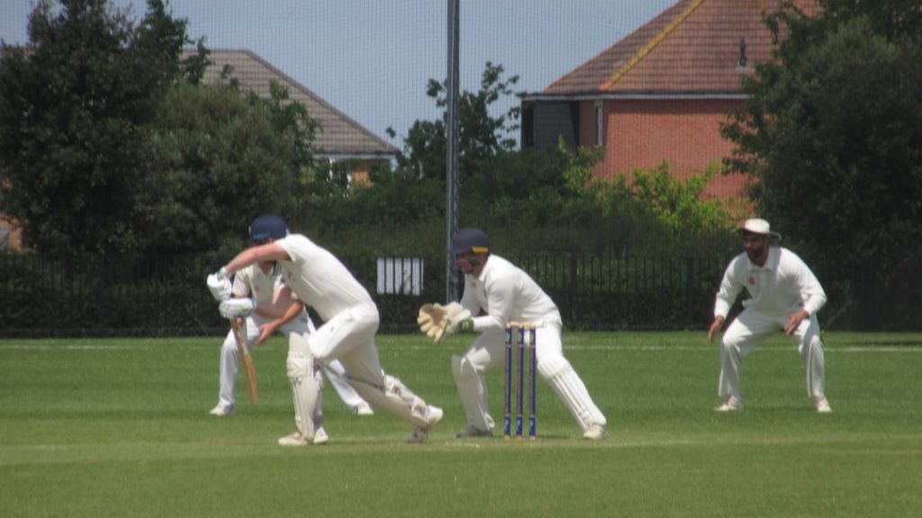 a group of men playing a game of cricket cricket warm up, dynamic stretching, amateur players field