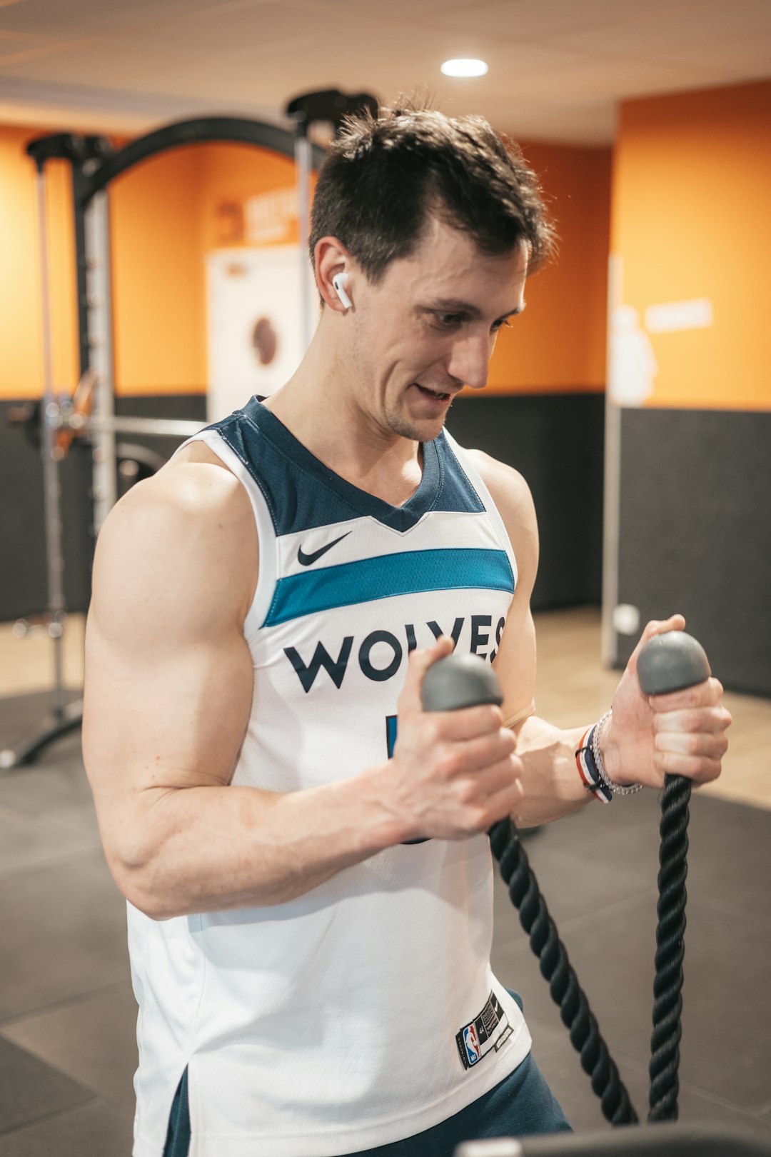 a man holding a rope in a gym athlete wearing smart sensors, sports performance lab, biometric monitoring equipment