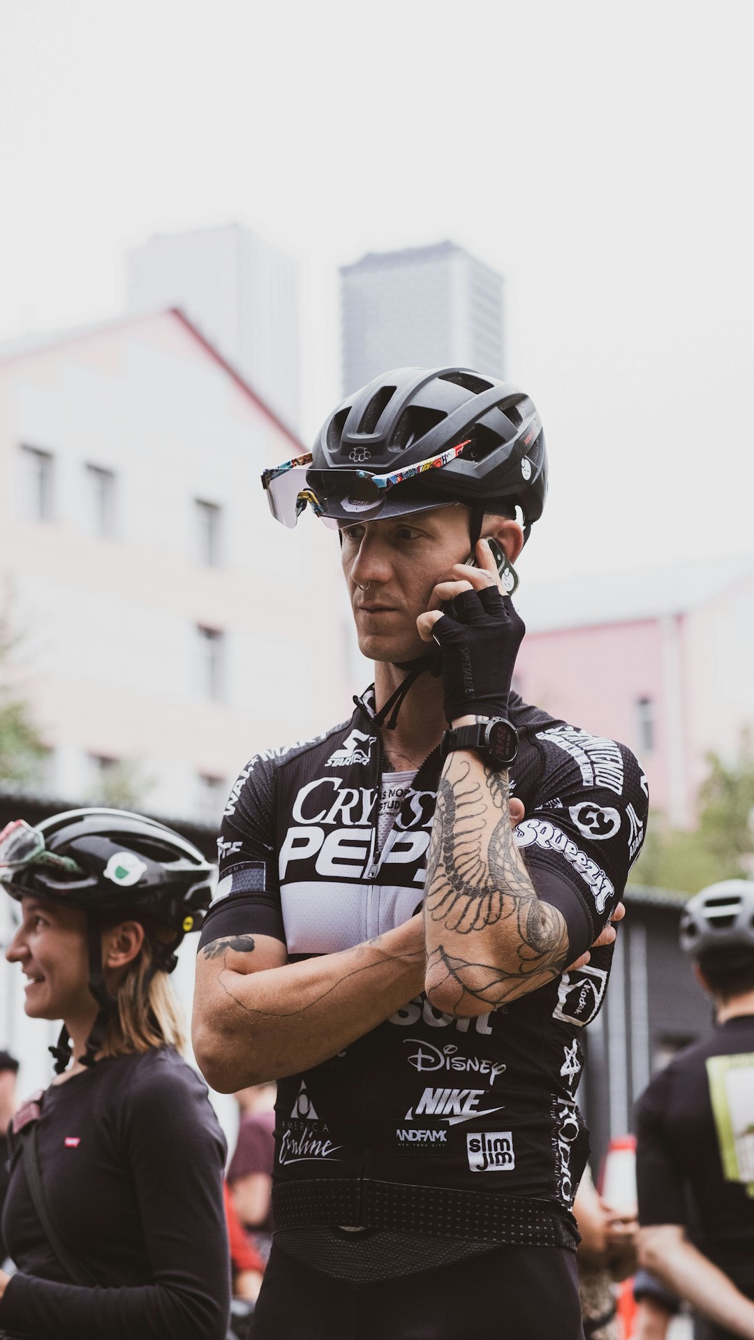 a man on a cell phone while wearing a bike helmet helmet top mount placement, masking tape positioning, cycling helmet setup