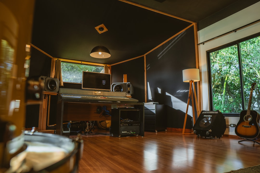 A recording studio with instruments and equipment. music artist typing bio, home studio setup, creative workspace