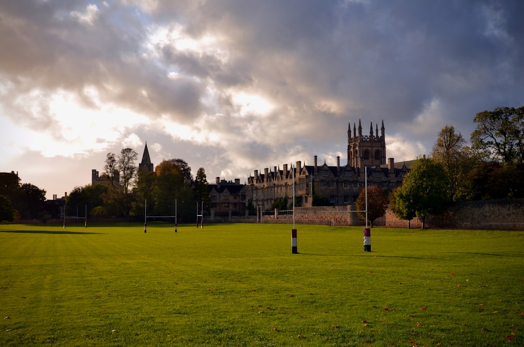 a soccer field with a castle in the background college lacrosse, university field, student athletes