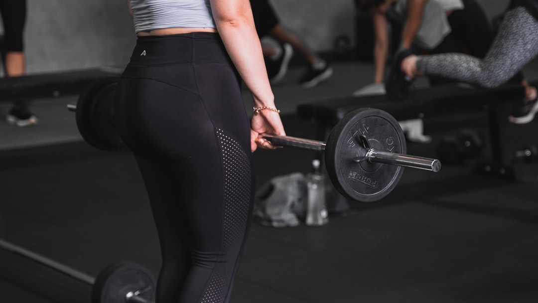 a woman lifting a barbell in a gym athlete bodyweight squat training indoor gym