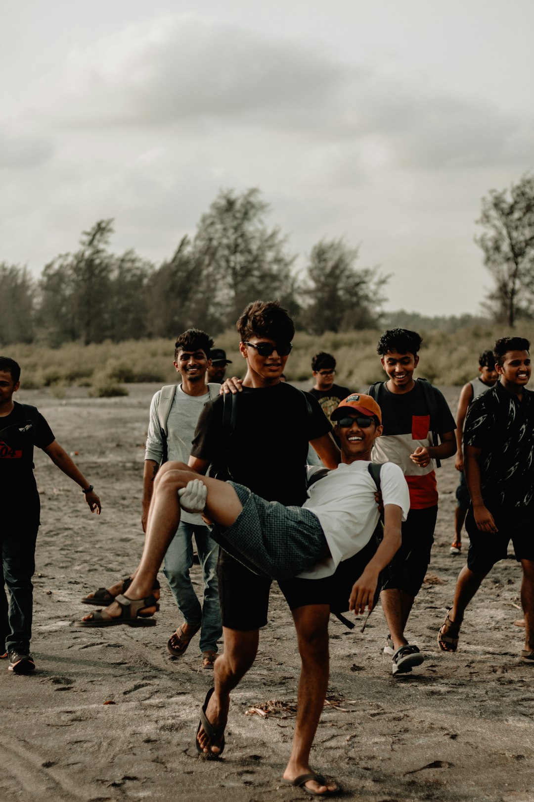 group of men walking near trees team bonding, camping trip, football players outdoors