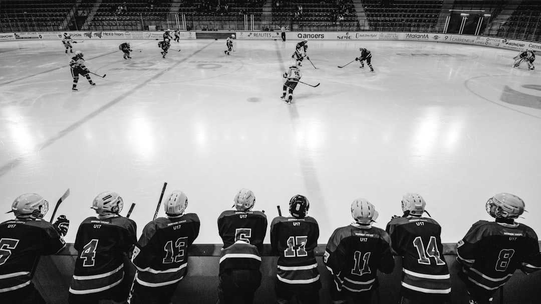 ice hockey players on ice hockey field hockey players bench, coach talking to team, NHL locker room