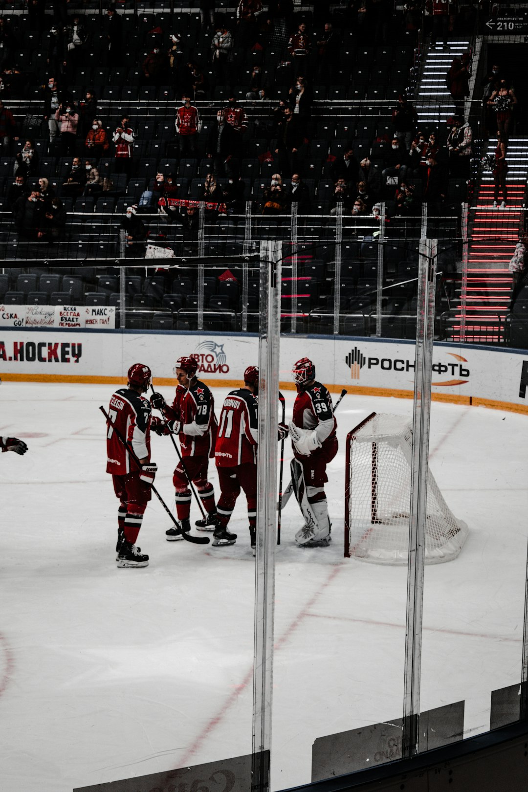 ice hockey players on ice hockey field hockey players bench, coach talking to team, NHL locker room