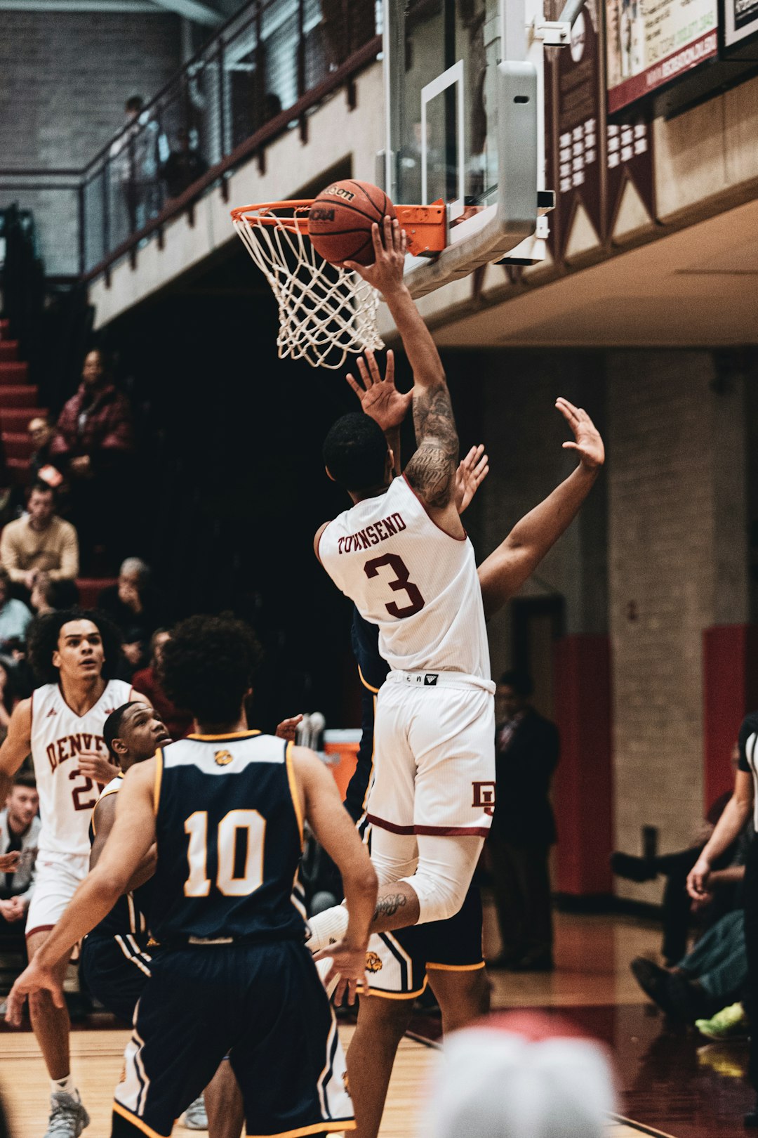 man in white and black basketball jersey shirt playing basketball basketball buzzer beater shot, indoor arena lights, dramatic jump shot