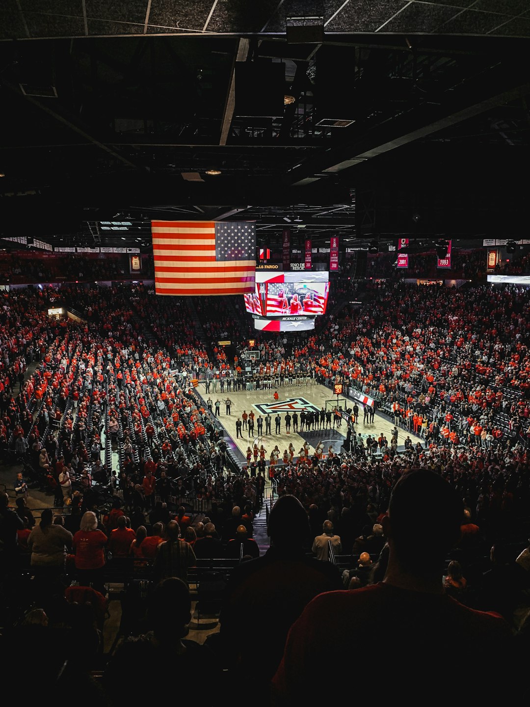 people watching a band on a concert sports journalist interviewing athlete, basketball arena background, courtside reporter with microphone