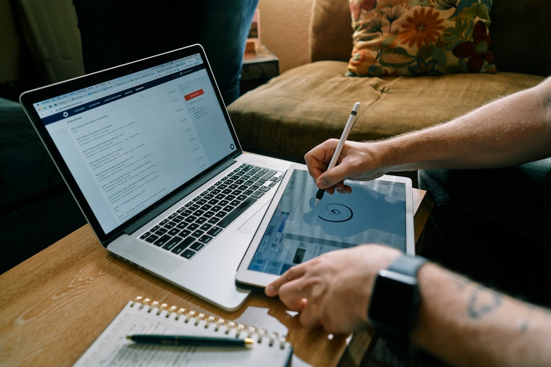 person writing on white paper person reviewing credit report on laptop, financial security concept, identity protection planning