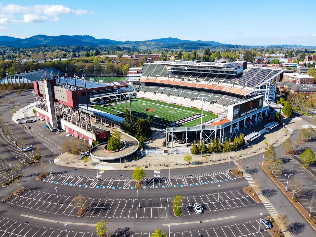 aerial view of green and brown building during daytime stadium parking lot, team colors, game day setup